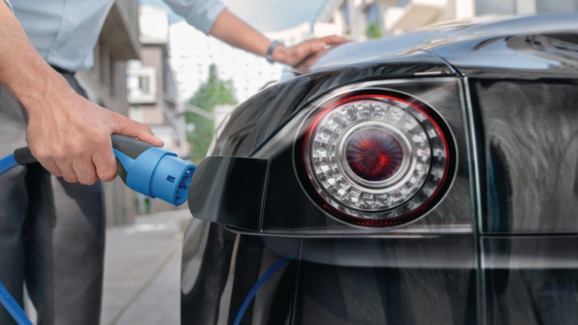 Man loading his electrical vehicle