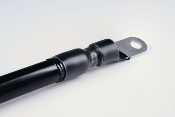 Semi-rigid halogen free polyolefin heat shrink tubing with an inner liner of hot melt adhesive.