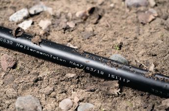 Medium wall, adhesive-lined heat shrink tubing for cable applications above and below the ground
